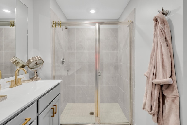 bathroom with vanity and a shower with door