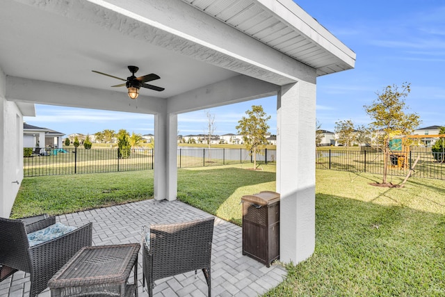 view of patio / terrace featuring a playground and ceiling fan