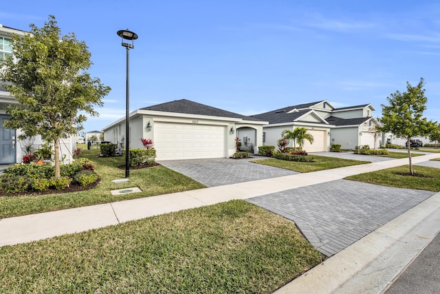 ranch-style home featuring a garage and a front lawn