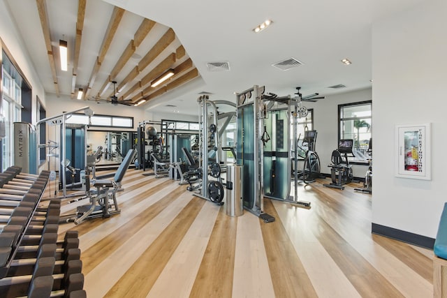 exercise room with light hardwood / wood-style floors and ceiling fan