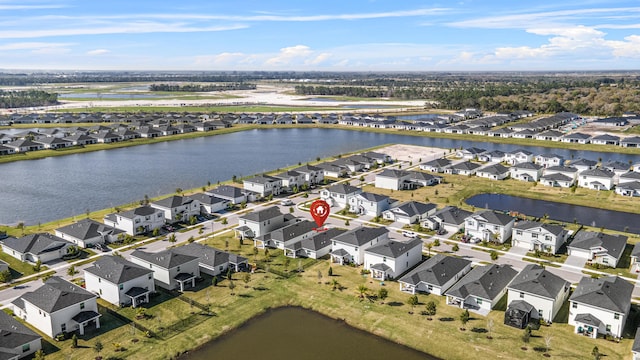 birds eye view of property with a water view