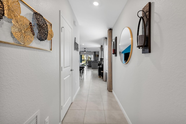 hallway featuring light tile patterned floors