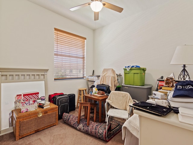 carpeted office featuring ceiling fan