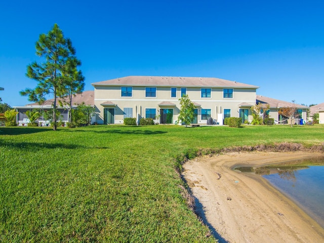 rear view of property with a lawn