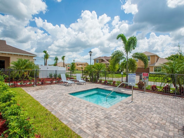 view of pool featuring a hot tub and a patio area