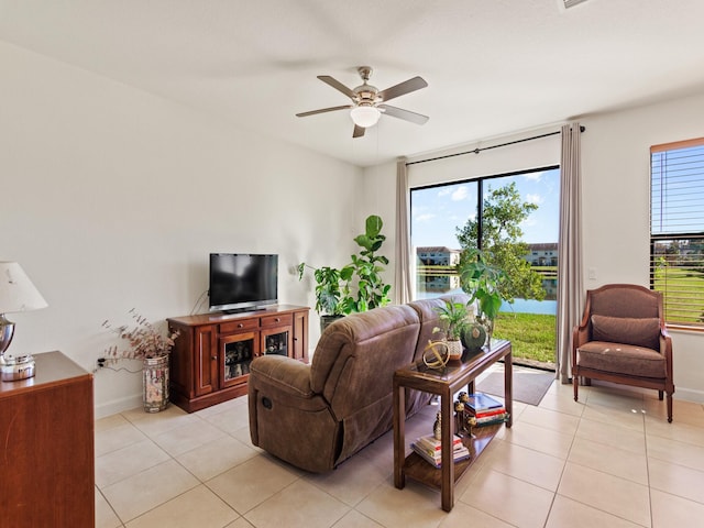 living room featuring plenty of natural light, light tile patterned floors, and ceiling fan