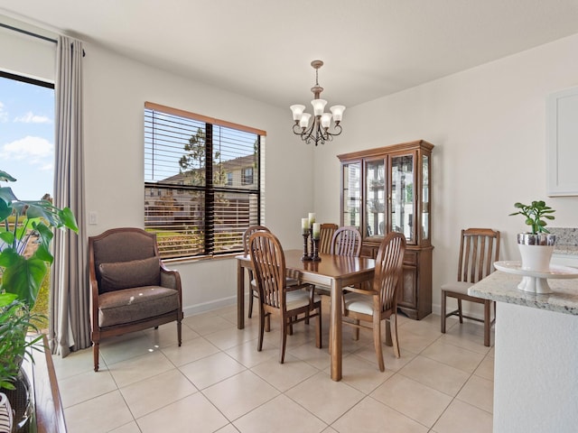 dining room with light tile patterned flooring and a chandelier