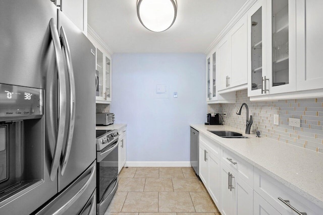 kitchen featuring white cabinetry, sink, tasteful backsplash, and appliances with stainless steel finishes