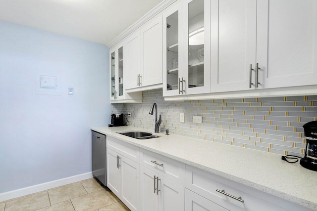 kitchen featuring sink, white cabinetry, tasteful backsplash, light tile patterned floors, and dishwasher