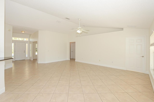 spare room with light tile patterned flooring, ceiling fan, and lofted ceiling