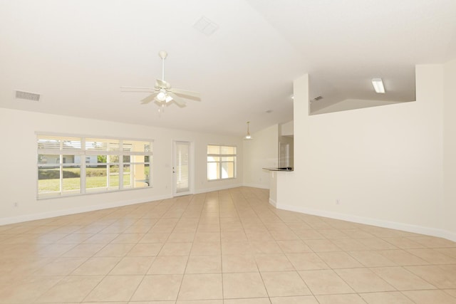 tiled empty room featuring ceiling fan and lofted ceiling