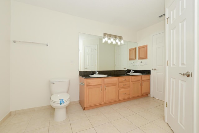 bathroom with tile patterned floors, vanity, and toilet