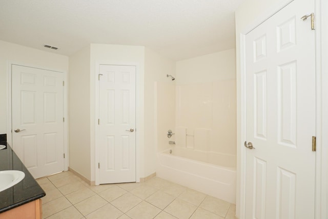 bathroom featuring tile patterned flooring, shower / tub combination, vanity, and a textured ceiling