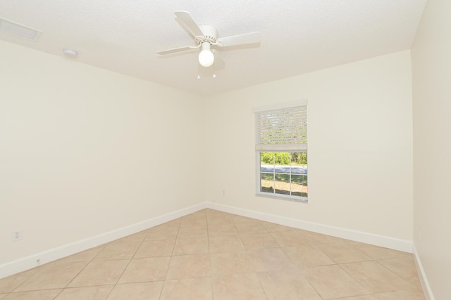 unfurnished room featuring ceiling fan, a textured ceiling, and light tile patterned floors