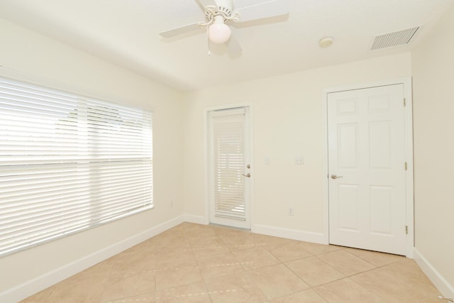 unfurnished bedroom featuring access to exterior, light tile patterned floors, and ceiling fan