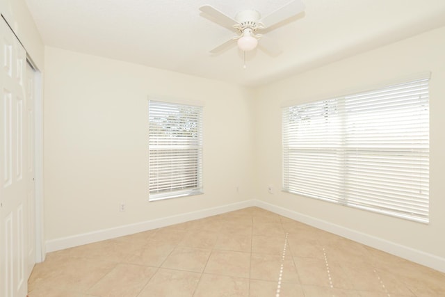 unfurnished room featuring light tile patterned flooring and ceiling fan