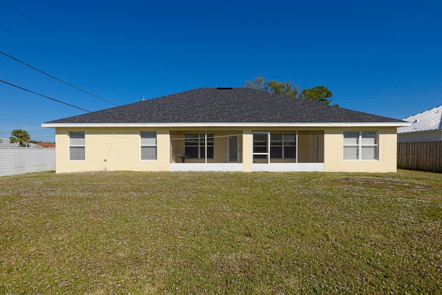 back of property featuring a lawn