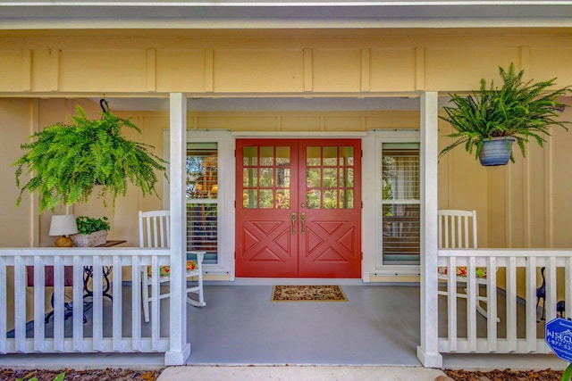 view of exterior entry featuring a porch