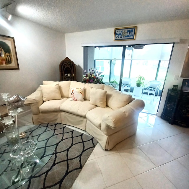 living room with light tile patterned floors and a textured ceiling