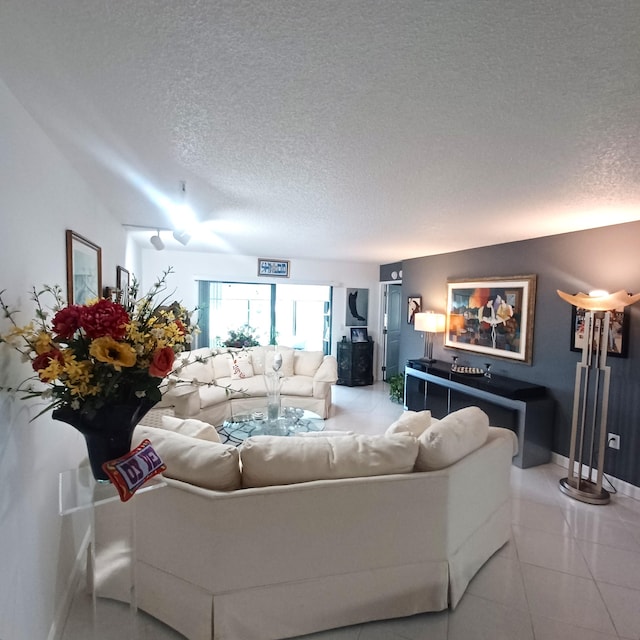 tiled living room featuring a textured ceiling