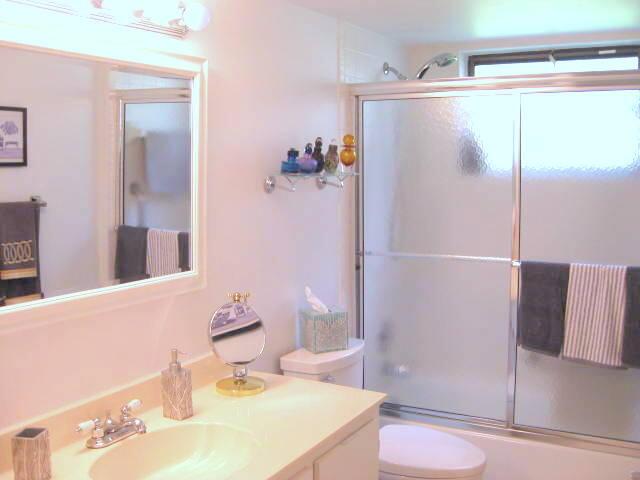 full bathroom featuring toilet, vanity, and shower / bath combination with glass door