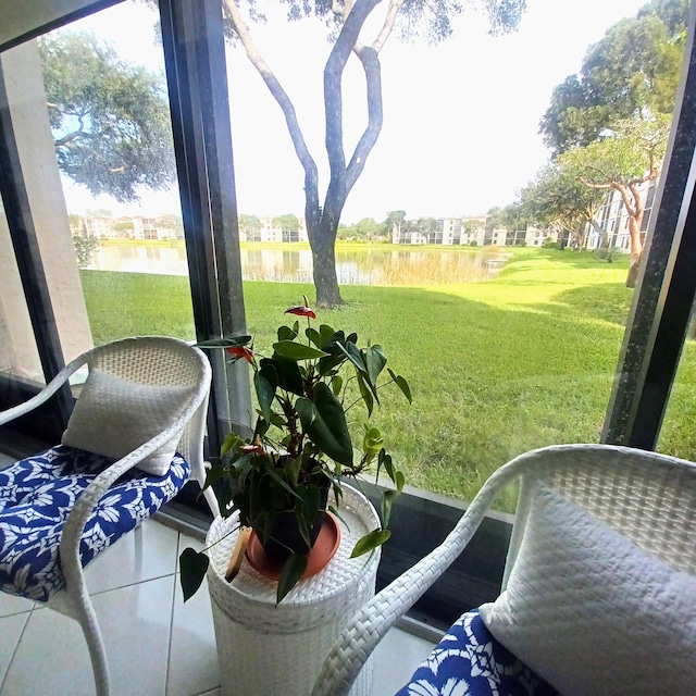 sunroom / solarium featuring a water view