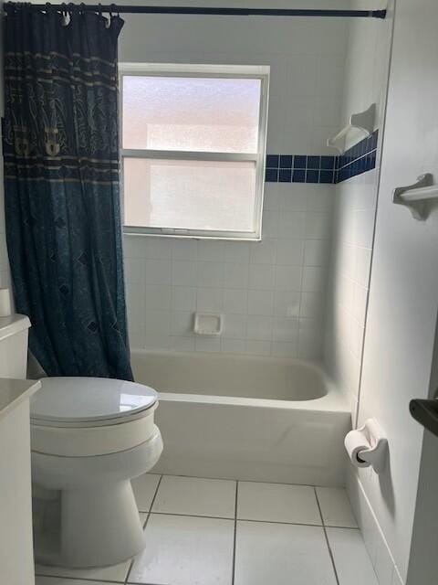 bathroom featuring toilet, tile patterned floors, and shower / bathtub combination with curtain