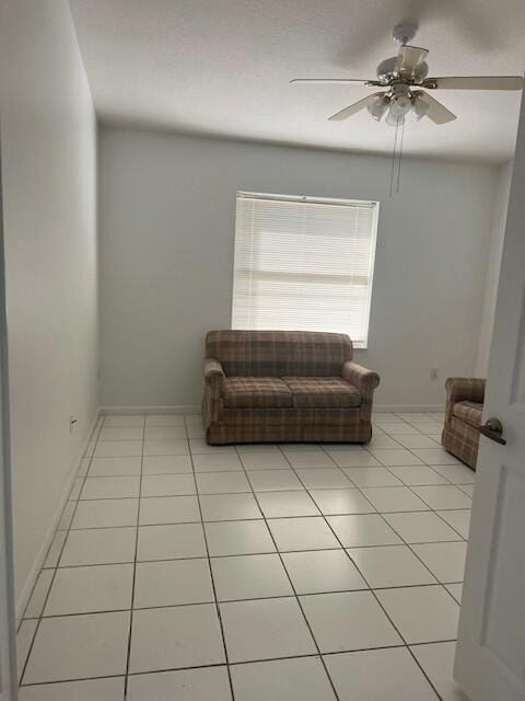 sitting room with light tile patterned floors and ceiling fan