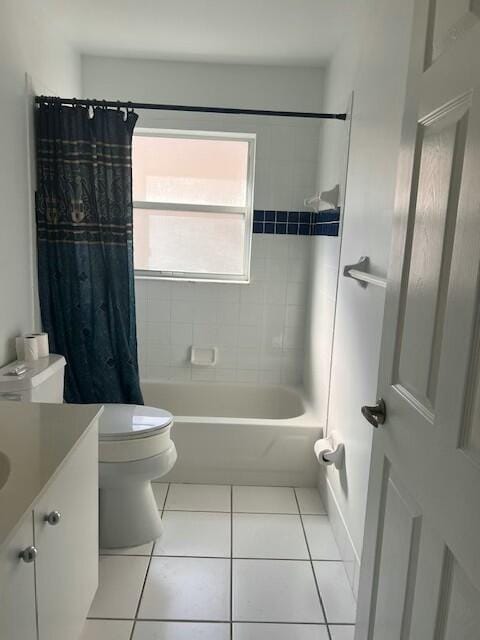 full bathroom with tile patterned flooring, vanity, shower / tub combo, and toilet