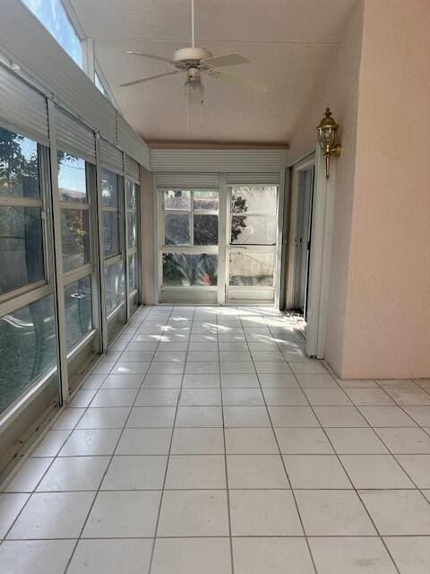 unfurnished sunroom with lofted ceiling and ceiling fan