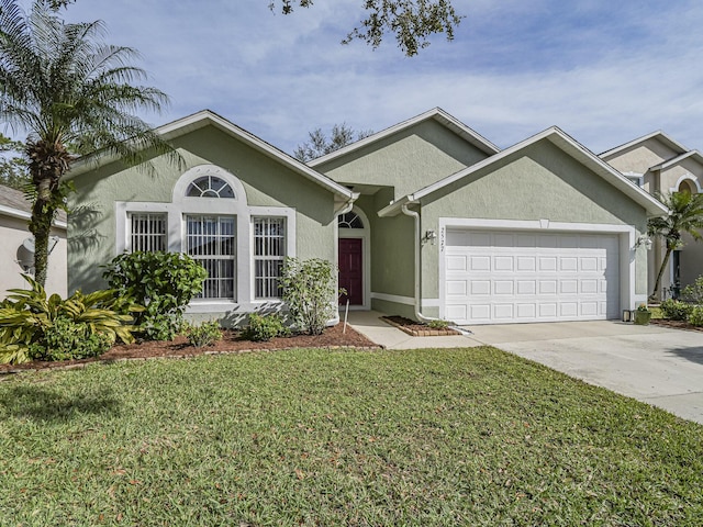 view of front of house featuring a garage and a front lawn