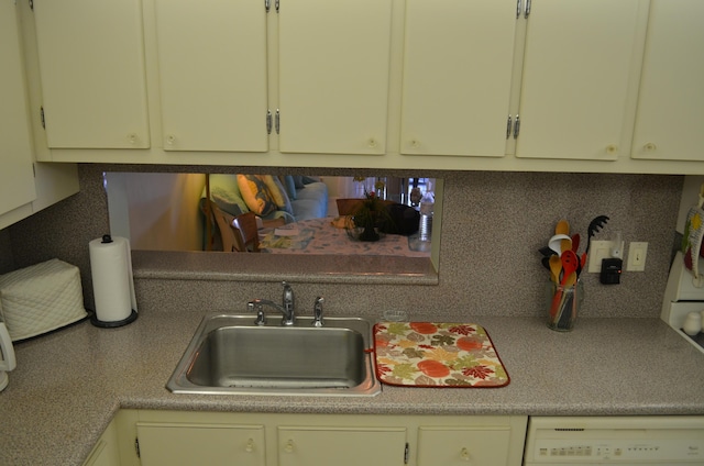 kitchen featuring tasteful backsplash, sink, and dishwasher