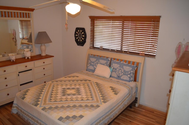 bedroom with hardwood / wood-style floors and ceiling fan