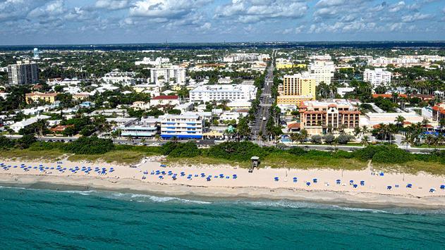 birds eye view of property with a beach view and a water view