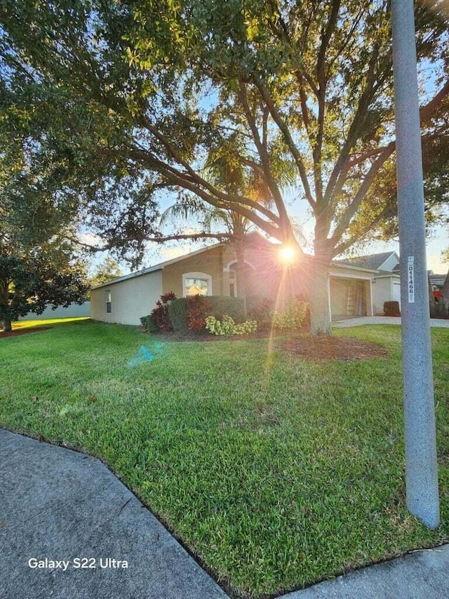 view of front of house with a garage and a front yard