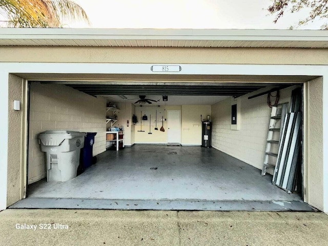 garage with water heater, electric panel, and ceiling fan