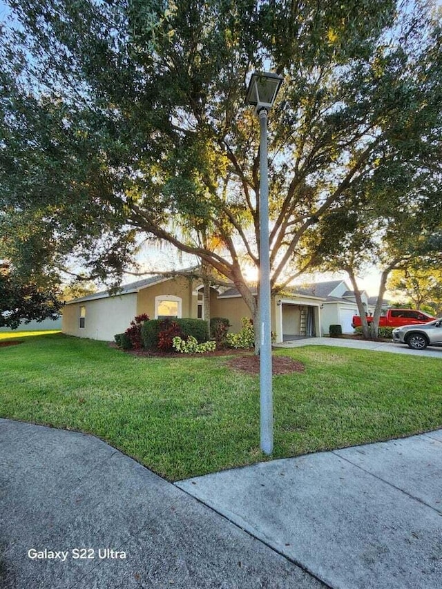 view of front of property with a garage and a front lawn