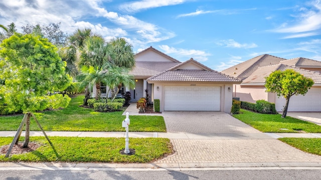 view of front of house featuring a garage and a front lawn