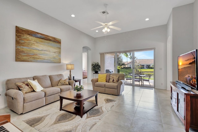 tiled living room featuring a towering ceiling and ceiling fan