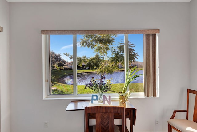 dining space featuring a water view