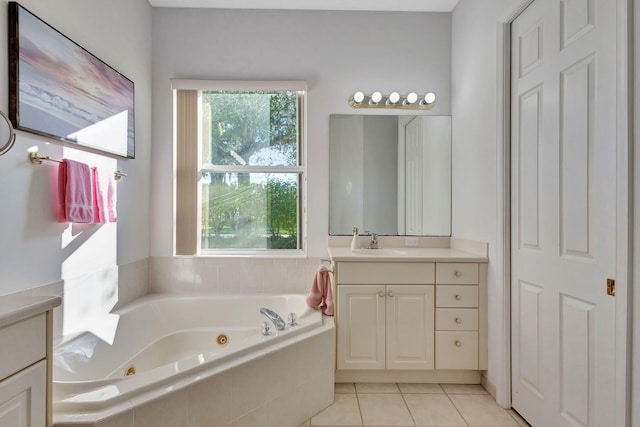 bathroom with vanity, tile patterned flooring, and tiled tub