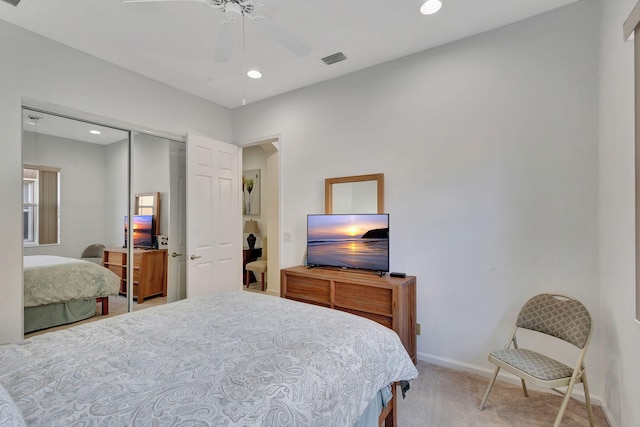 carpeted bedroom featuring a closet and ceiling fan