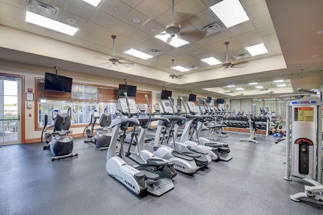 exercise room with ceiling fan and a drop ceiling