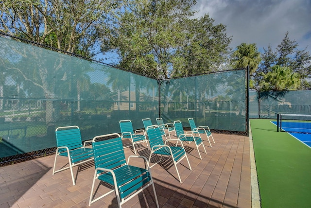 view of patio / terrace with tennis court