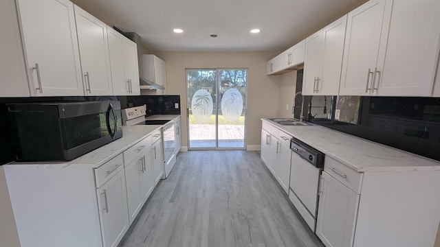 kitchen with sink, backsplash, white cabinets, and white appliances