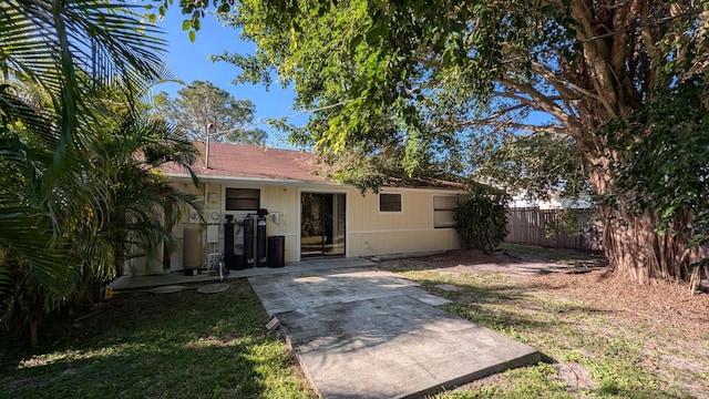 rear view of house with a yard