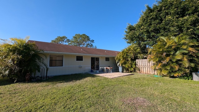 back of property featuring a yard and a patio area