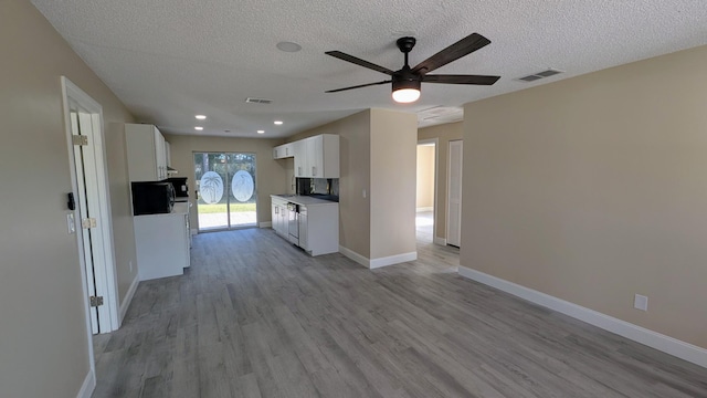 kitchen with ceiling fan, a textured ceiling, light hardwood / wood-style floors, and white cabinets