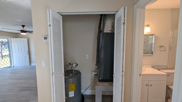 utility room featuring water heater