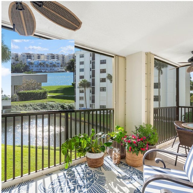 balcony with a ceiling fan and a water view